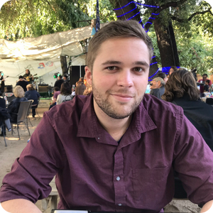 Man smiling with purple dress shirt