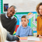 Parents visiting with child at school and meeting with teacher