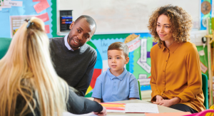 Parents visiting with child at school and meeting with teacher