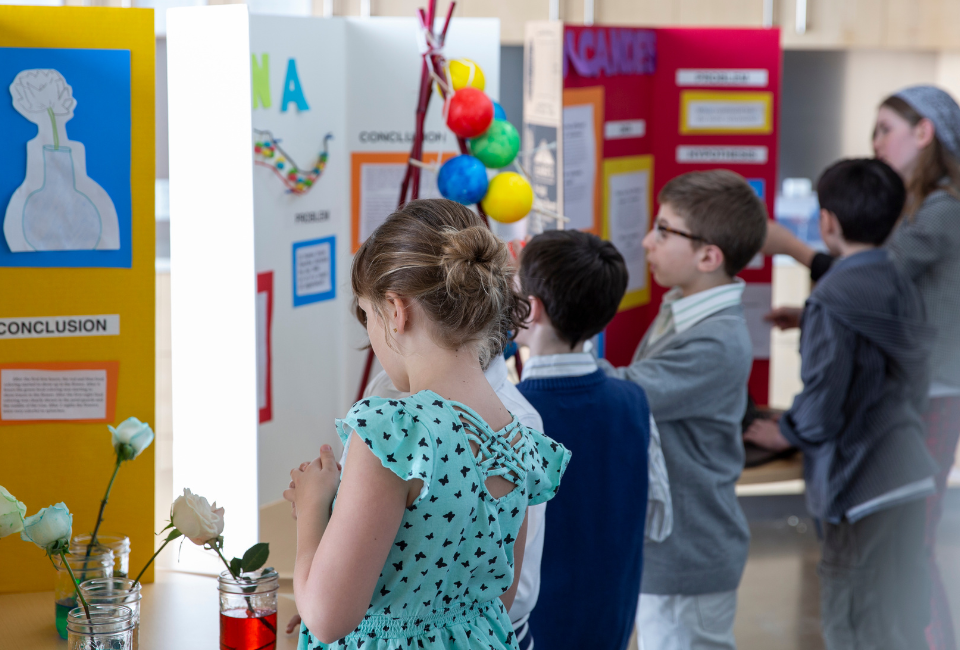 Elementary students showcasing projects at a school tour for choice week.