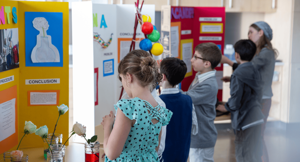 Elementary students showcasing projects at a school tour for choice week.