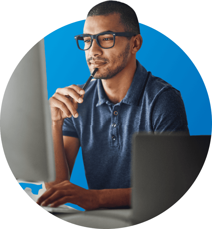 teacher with glasses working on computer