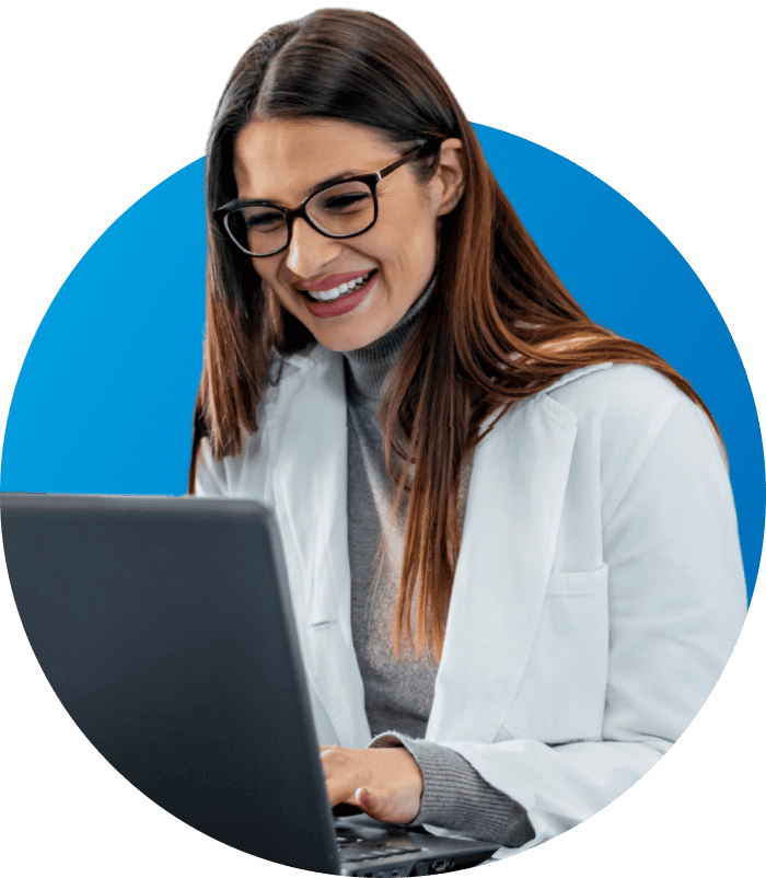 teacher in glasses working on laptop