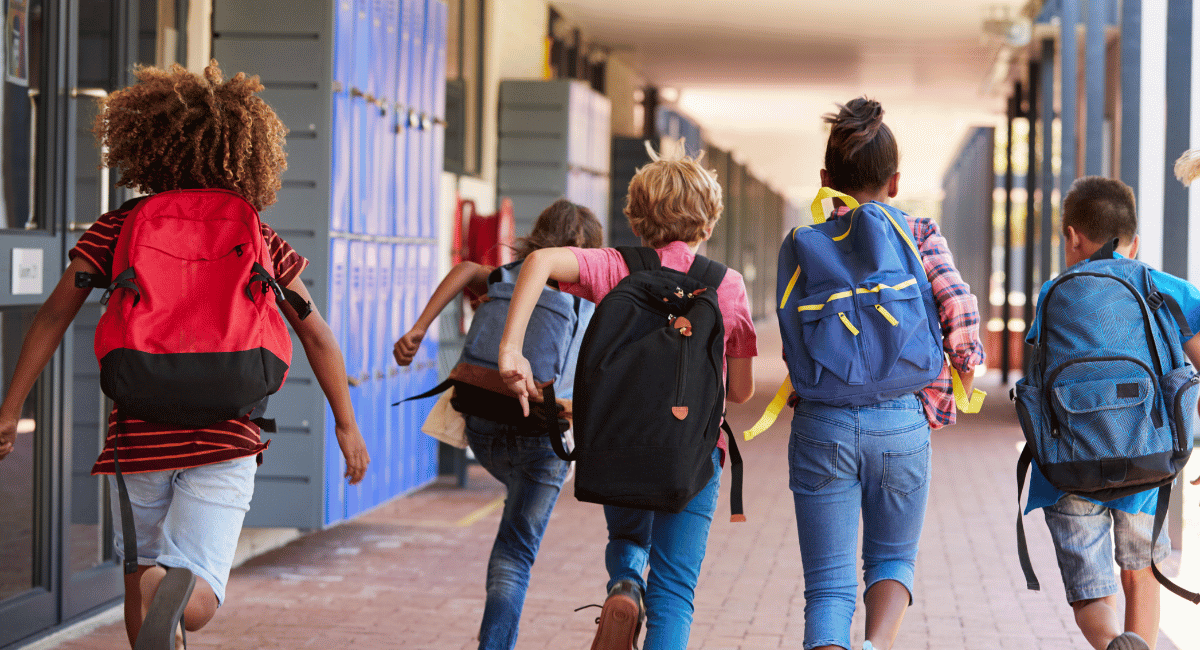 school kids running towards class