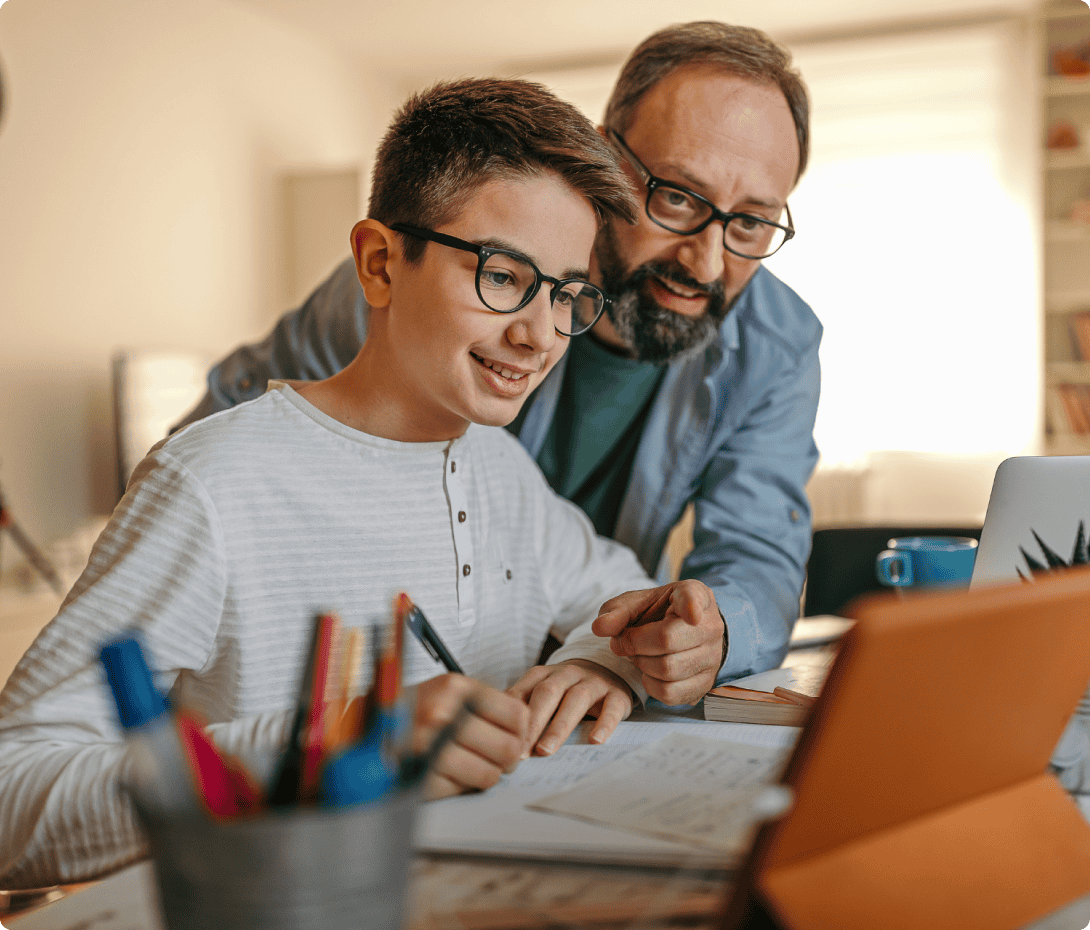 male student with his father helping him with his homework