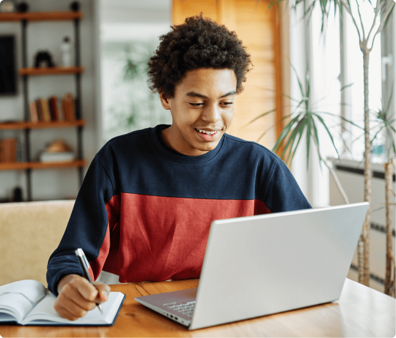 Male student working on his homework on this laptop