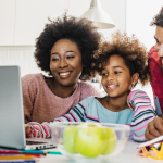 Parents with child looking at the computer for lottery results