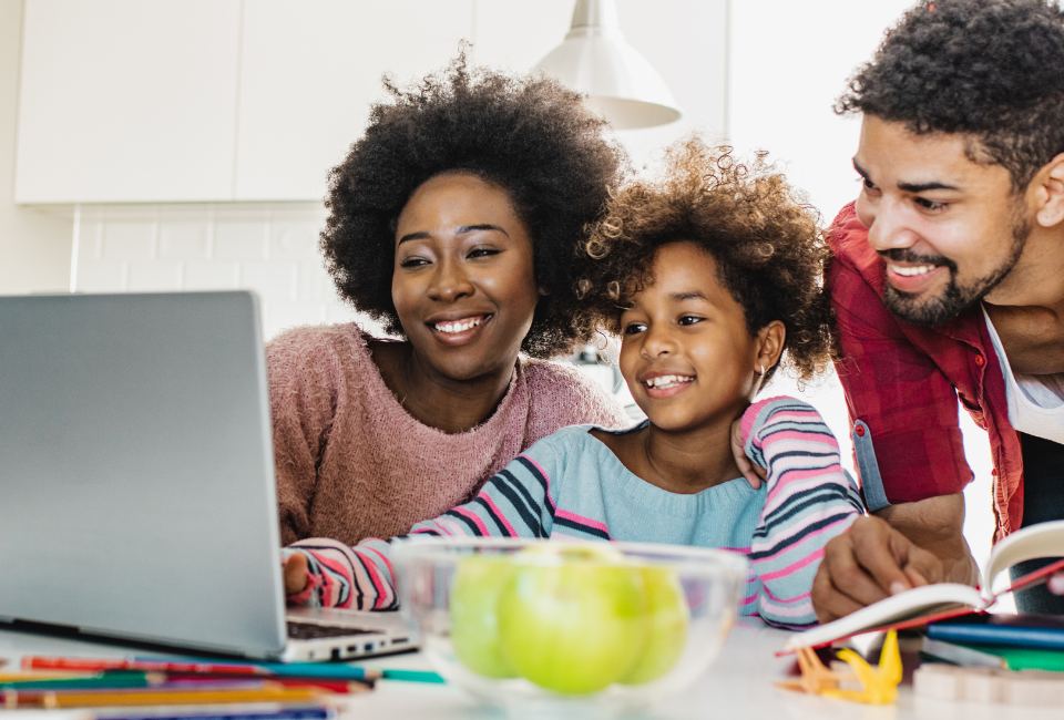 Parents with child looking at the computer for lottery results