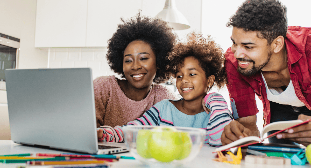 Parents with child looking at the computer for lottery results