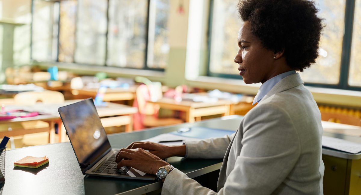 Teacher auditing her school lottery system on her laptop in the classroom.