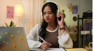 girl-wears-headphones-while-doing-independent-study