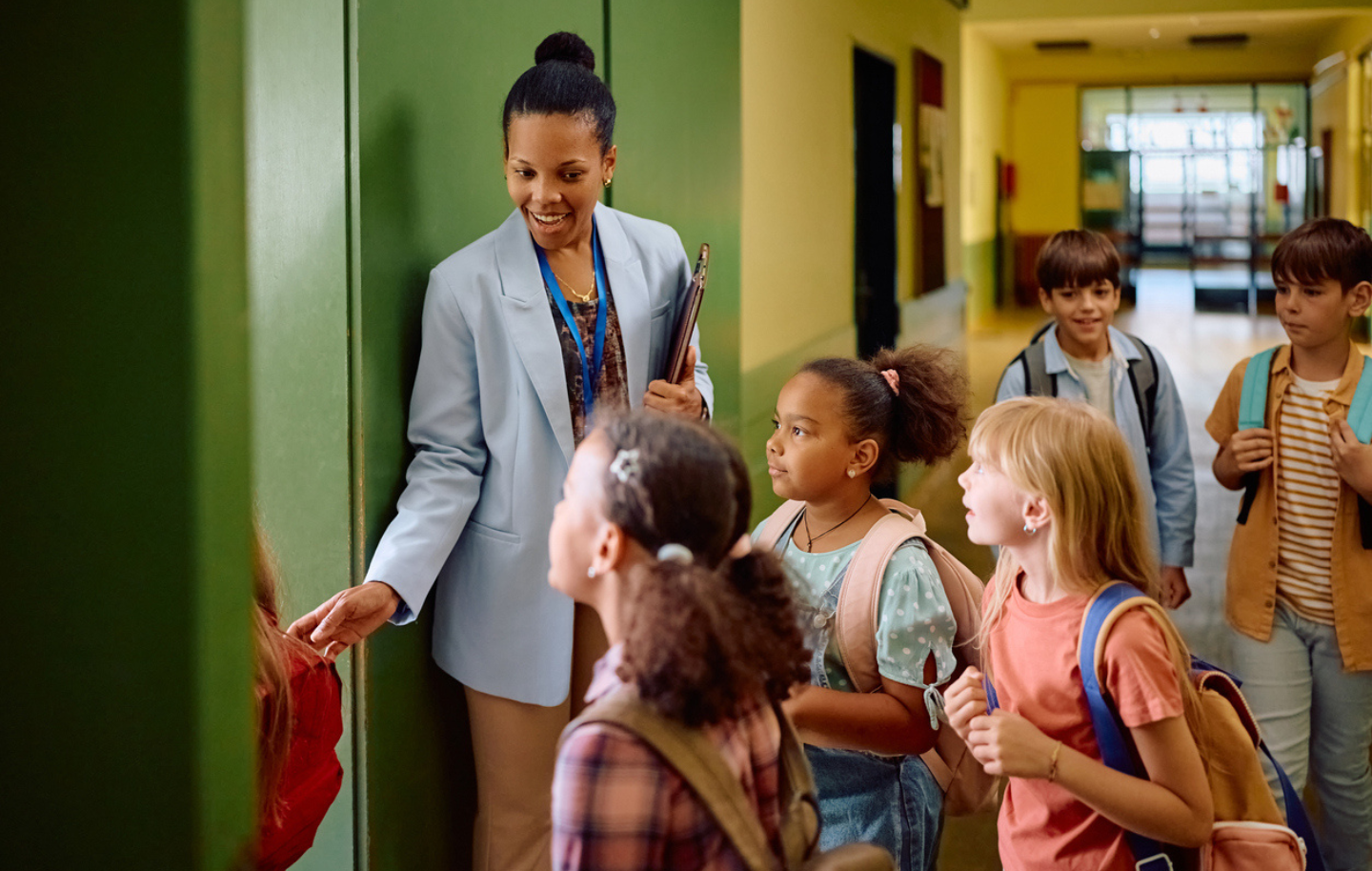 teacher-welcoming-students-into-new-charter-school