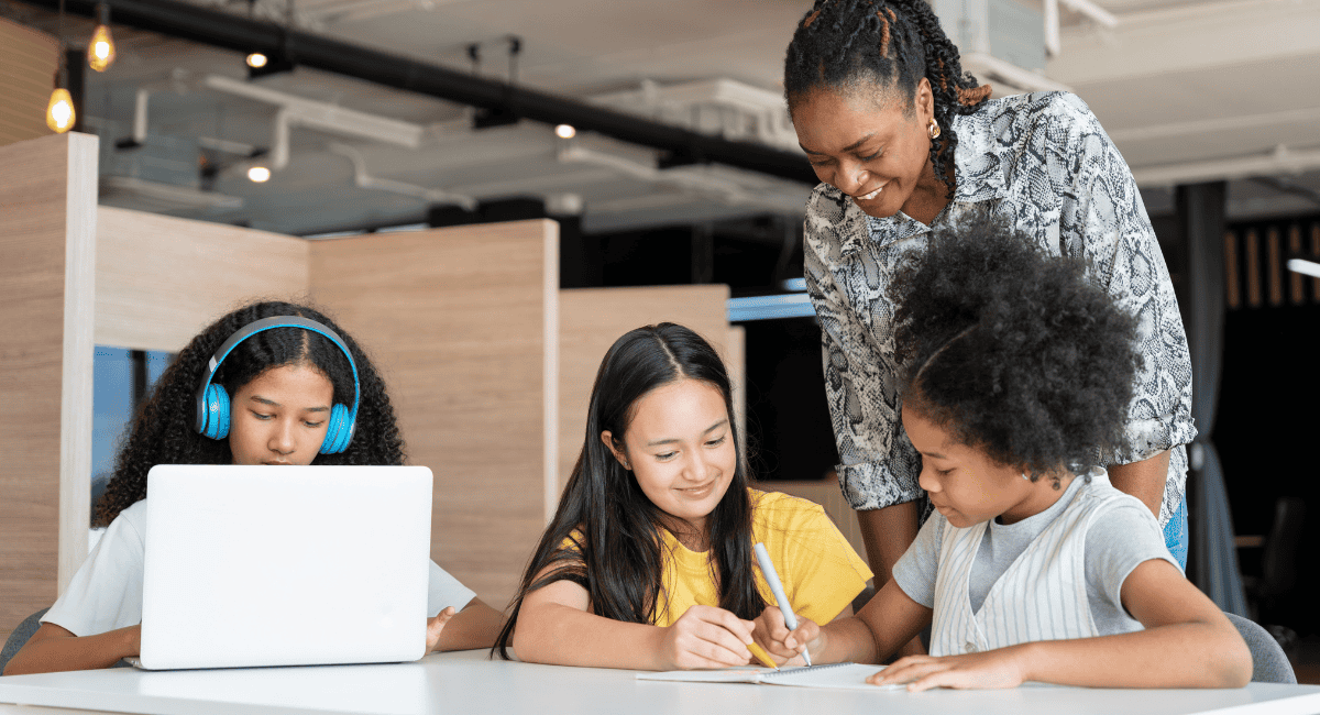 teacher-works-with-students-studying-on-computer